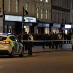 Police tape blocks off a busy Oxford Street after a fatal stabbing incident in central London.