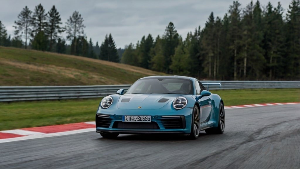 Porsche 911 hybrid prototype on Stuttgart test track with P911 -2.1% stock dip and CEO Oliver Blume overlay October 29 2025